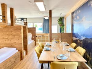 a dining room with a wooden table and chairs at Best Butler Active Alpin Hund Küche Parken in Füssen