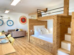 a bedroom with a bunk bed and a living room at Best Butler Active Alpin Hund Küche Parken in Füssen