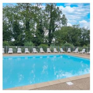 a large blue swimming pool with lounge chairs at Home Sweet Home in Gex
