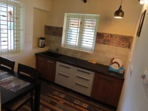 a kitchen with a sink and a counter top at Misty Hills Retreat in Coimbatore