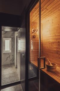 a bathroom with a wooden wall with a tub at La bella vita luxury apartament and travel solution in Naples