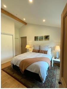 a bedroom with a large bed and two lamps at Gibbston - Wake up in the vines in Gibbston