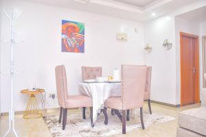 a dining room with a table and chairs at Chic 2-Bedroom Haven in Kilimani in Nairobi