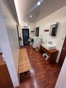 a bathroom with a sink and a mirror at プロジェクター完備でBBQグリル無料貸し出しのフクギのお家はSesoko一棟貸 in Sesoko +34 photos