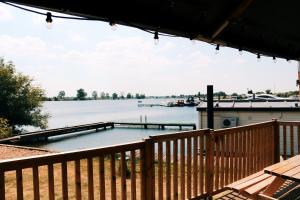 a large swimming pool on a deck with a view of the water at Luxury Lake Lodge in Alphen