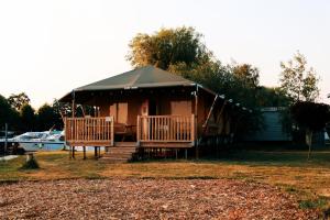 a gazebo with a black roof in a yard at Luxury Lake Lodge in Alphen