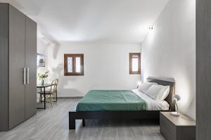 a bedroom with a bed and a table with a chair at Teatro Massimo Central Elegant Apartment x5 in Palermo