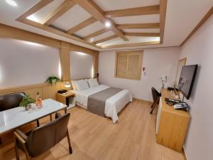 a hotel room with a bed and a table and chairs at LEX Tourist Hotel in Seoul