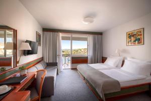 Postel nebo postele na pokoji v ubytování Maistra Select Pineta Hotel