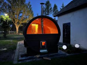 un pequeño horno está sentado fuera de una casa en Agroturystyka ANTONIELÓW POD DĘBEM, 