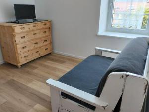 a bedroom with a bed and a desk and a dresser at Camera con bagno privato in Tesero