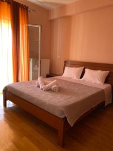 a bedroom with a bed with two towels on it at Olive Garden House in Ágios Prokópios