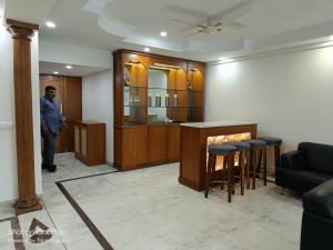 a man standing in a living room with a fireplace at Modern Room(R1) in Heart of City in New Delhi