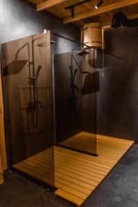 a room with a shower with a glass wall at Hostel VinoGrad in Haysyn