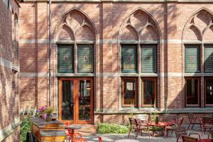 a brick building with tables and chairs in front of it at Hotel Staatsman in Zwolle
