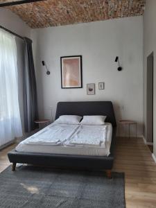 a bedroom with a bed and two tables in it at Quiet green oasis in city center in Cluj-Napoca