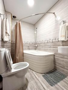 a bathroom with a tub and a toilet and a sink at Hotel Khiva Palace in Khiva