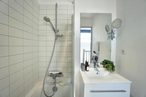 a white bathroom with a sink and a shower at Cabine de plage n°2 *50m de la plage* in Ploemeur +23 photos