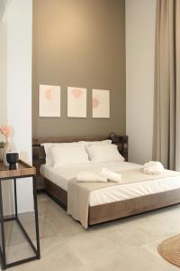 a bedroom with a bed with two towels on it at UrbanBay Hotel & Spa in Kavála