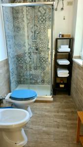 a bathroom with a shower and a toilet and a sink at Àrima Mondello Apartment in Mondello
