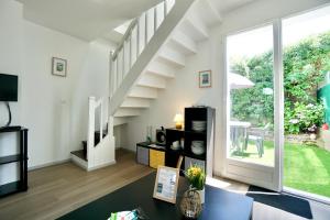 a living room with a staircase in a house at Cabine de plage n°2 *50m de la plage* in Ploemeur