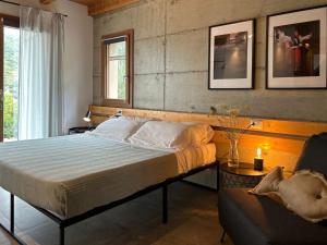 a bedroom with a large bed and a chair at Sa Guardia de Ferricci in Solanas