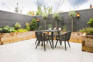a patio with a table and chairs in a garden at Beautiful boutique feel centrally located in Hereford
