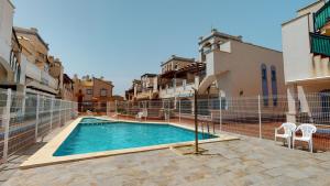 a swimming pool in the middle of some buildings at Casa Mandolina - A Murcia Holiday Rentals Property in Murcia