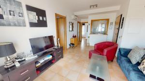 a living room with a couch and a tv at Casa Mandolina - A Murcia Holiday Rentals Property in Murcia