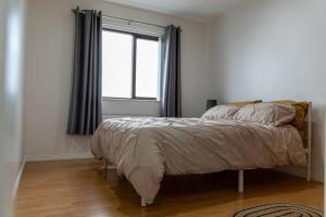 a bedroom with a bed and a window at Ligford Cottage in Strabane