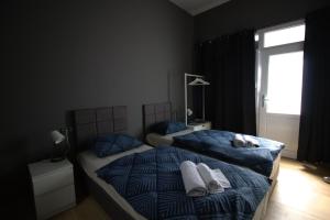 a bedroom with two beds and a window at Rooms Matić in Velika Mlaka