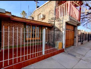 a fence on the side of a brick building at Sophenia in Agrelo