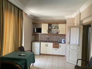 a small kitchen with a table and a counter top at Serendi Apart Hotel in Alanya