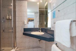 a bathroom with a sink and a shower at Holiday Inn Express Taunton East by IHG in Taunton