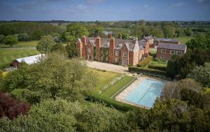 an aerial view of a large brick house with a swimming pool at Vavasour in York