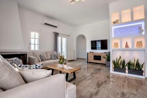 a living room with a couch and a fireplace at Villa Nostos in Dhragoulás