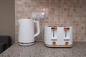two white coffee makers sitting on top of a counter at Cosy Cottage in Historic Lincoln in Lincolnshire