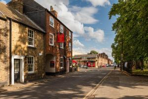 an empty street in a town with brick buildings at Cosy Cottage in Historic Lincoln in Lincolnshire