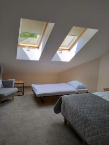 a bedroom with two beds and two skylights at Big Marc in Krynica Zdrój +12 photos