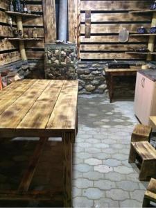 einen Holztisch in einem Zimmer mit zwei Bänken in der Unterkunft Sunset Krikhi in Ambrolauri