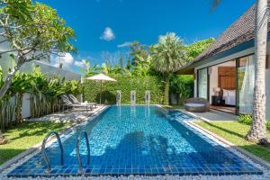 a swimming pool in the backyard of a villa at Escape Villas - Luxury Pool Villa at Anchan Villas in Ban Phru Champa