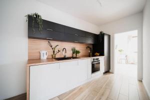 a kitchen with a sink and a counter top at City Center - 3 Rooms - New Building - Private Parking Place - Garage in Wrocław