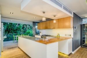 a kitchen with a counter and a large window at The Cheviots in Cape Town