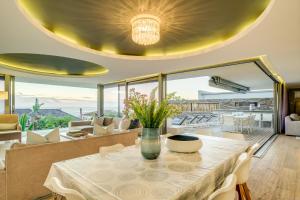 a dining room with a table with a vase on it at The Cheviots in Cape Town