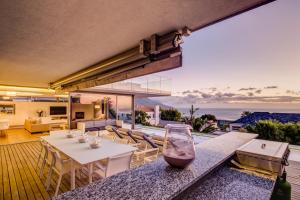 a dining room and living room with a view of the ocean at The Cheviots in Cape Town