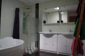 a bathroom with a sink and a toilet and a tub at Domaine Joseph LAFARGE Wine Resort B&B in Lugny