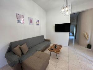 a living room with a couch and a table at Minimalist Flat with Balcony in Heraklio Town