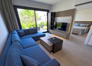 a living room with a blue couch and a television at Galimera in Bodrum City