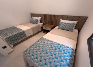 a bedroom with two beds and a table at Galimera in Bodrum City