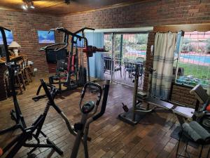 a gym with treadmills and elliptical machines at Emani Guest House in Mokopane